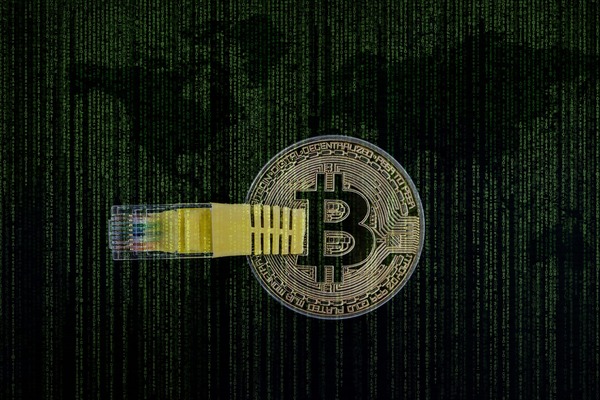 Bitcoin coin over a digital binary code world map background representing blockchain privacy
