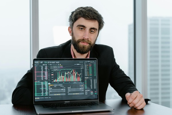 Trader reviewing a cryptocurrency exchange rate chart on a laptop before confirming an order
